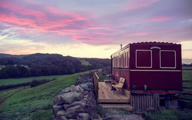 The Flying Yorkshireman train carriage accomodation overlooking a purple sunset