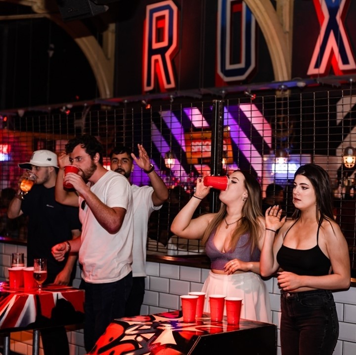 people playing beer pong at Roxys