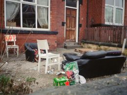 front of a house in Hyde Park with a sofa and rubbish outside