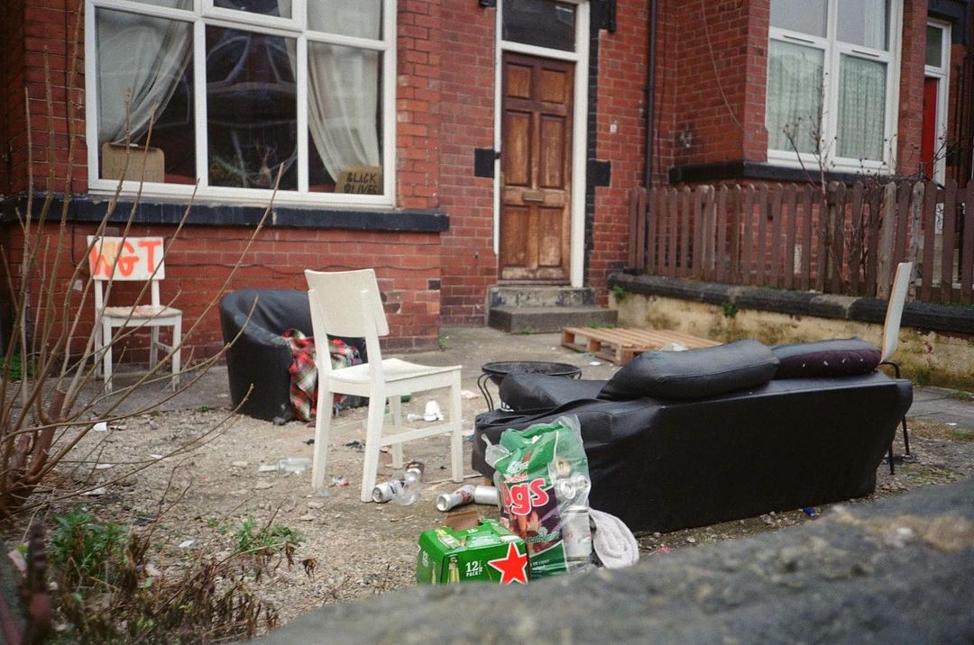 front of a house in Hyde Park with a sofa and rubbish outside