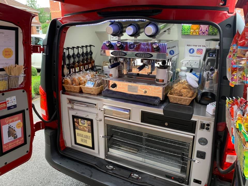 back of van with coffee machine and food inside