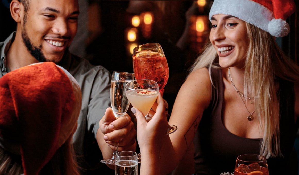 people drinking with santa hats on in Manahatta at a Christmas bottomless