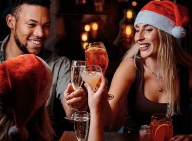 people drinking with santa hats on in Manahatta at a Christmas bottomless