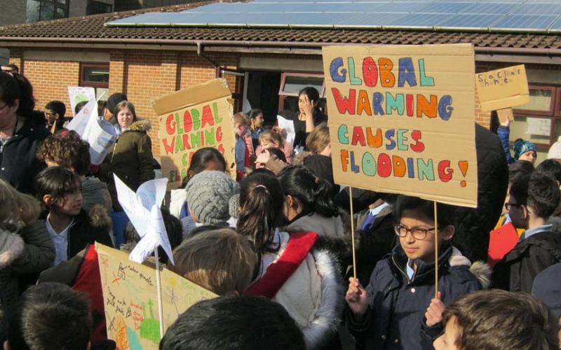 children with climate change placards