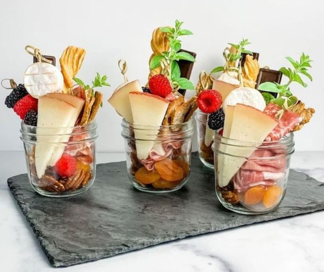 cheese, meat and fruit in a jar.