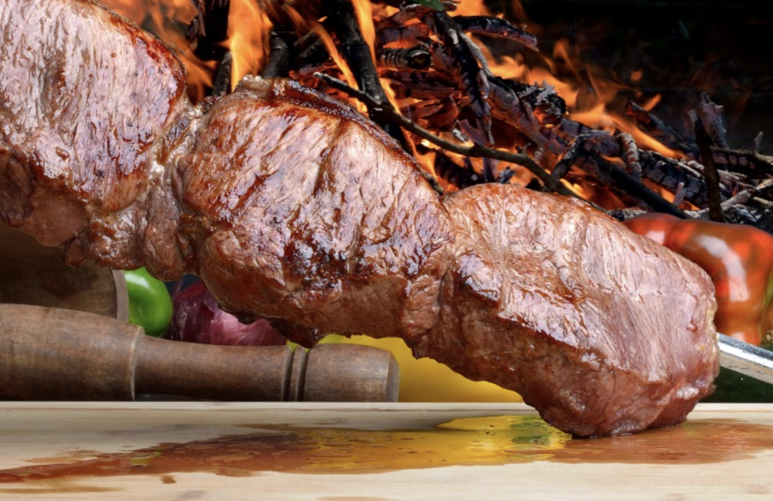 meat cooking on a skewer.