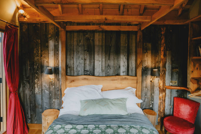 bed inside treehouse.