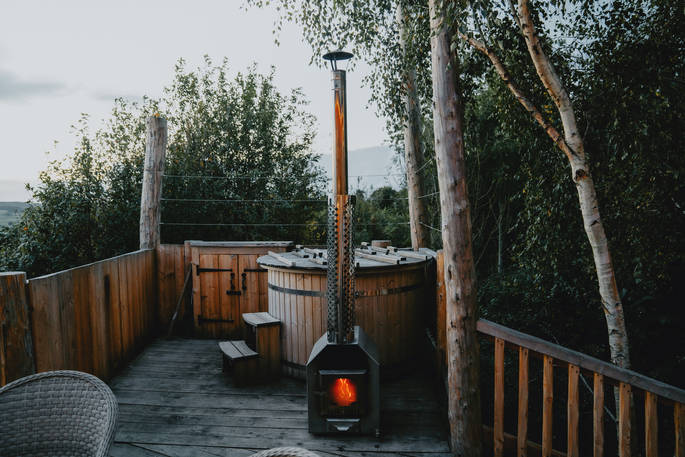 outdoor hot tub with fire.