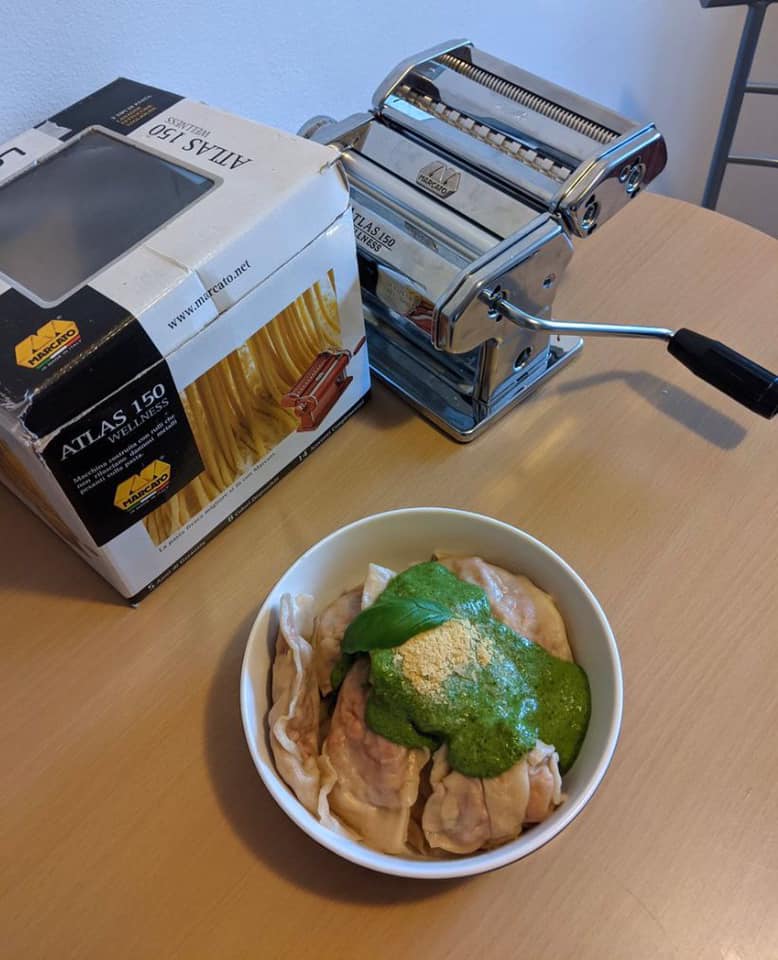 ravioli maker and box with a bowl of pasta.