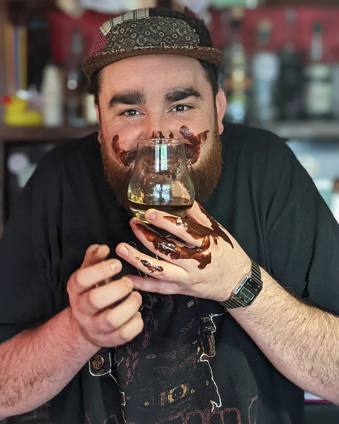 man sniffing glass.