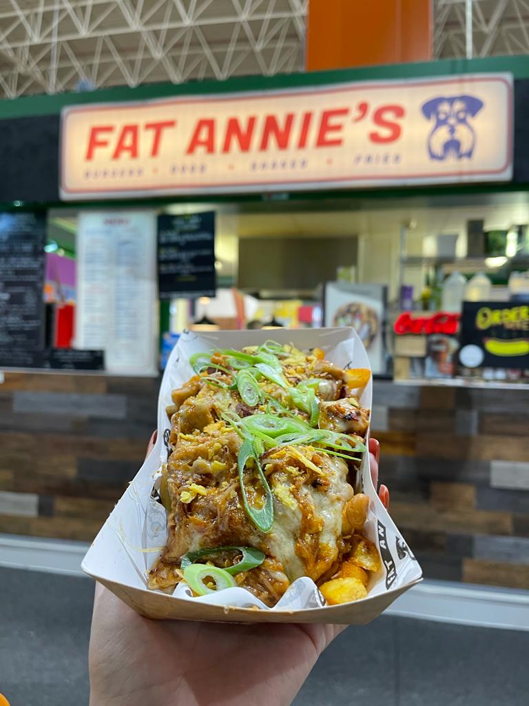 Vegan fries next to sign.