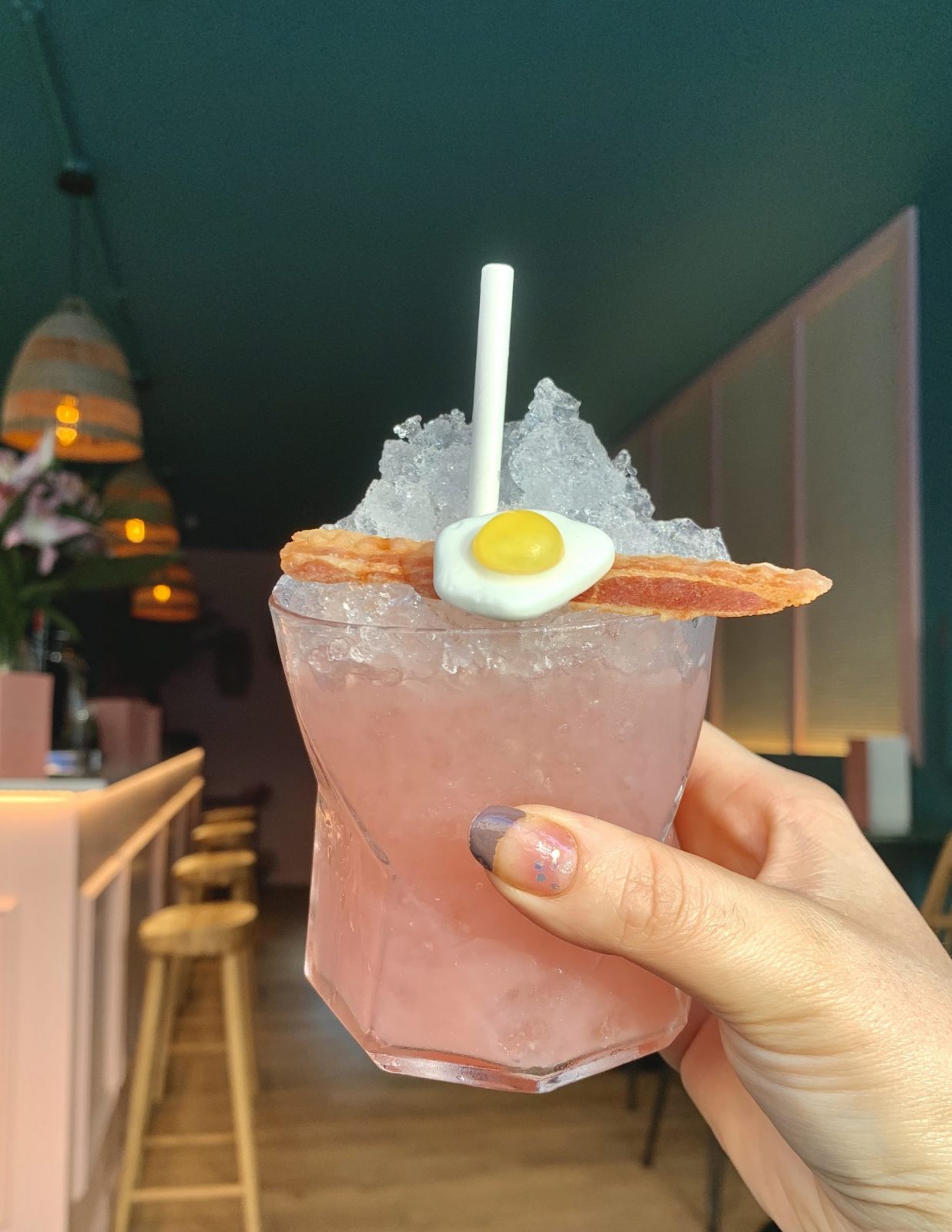 A cocktail held in a hand.