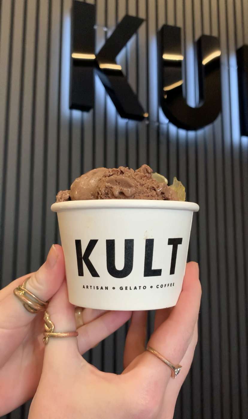 ice cream next to KULT sign.
