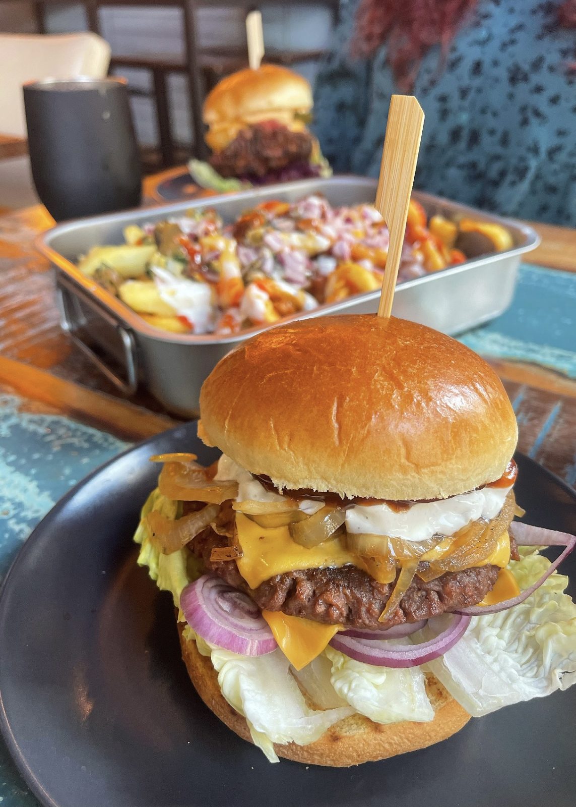 vegan burger with loaded fries on a table