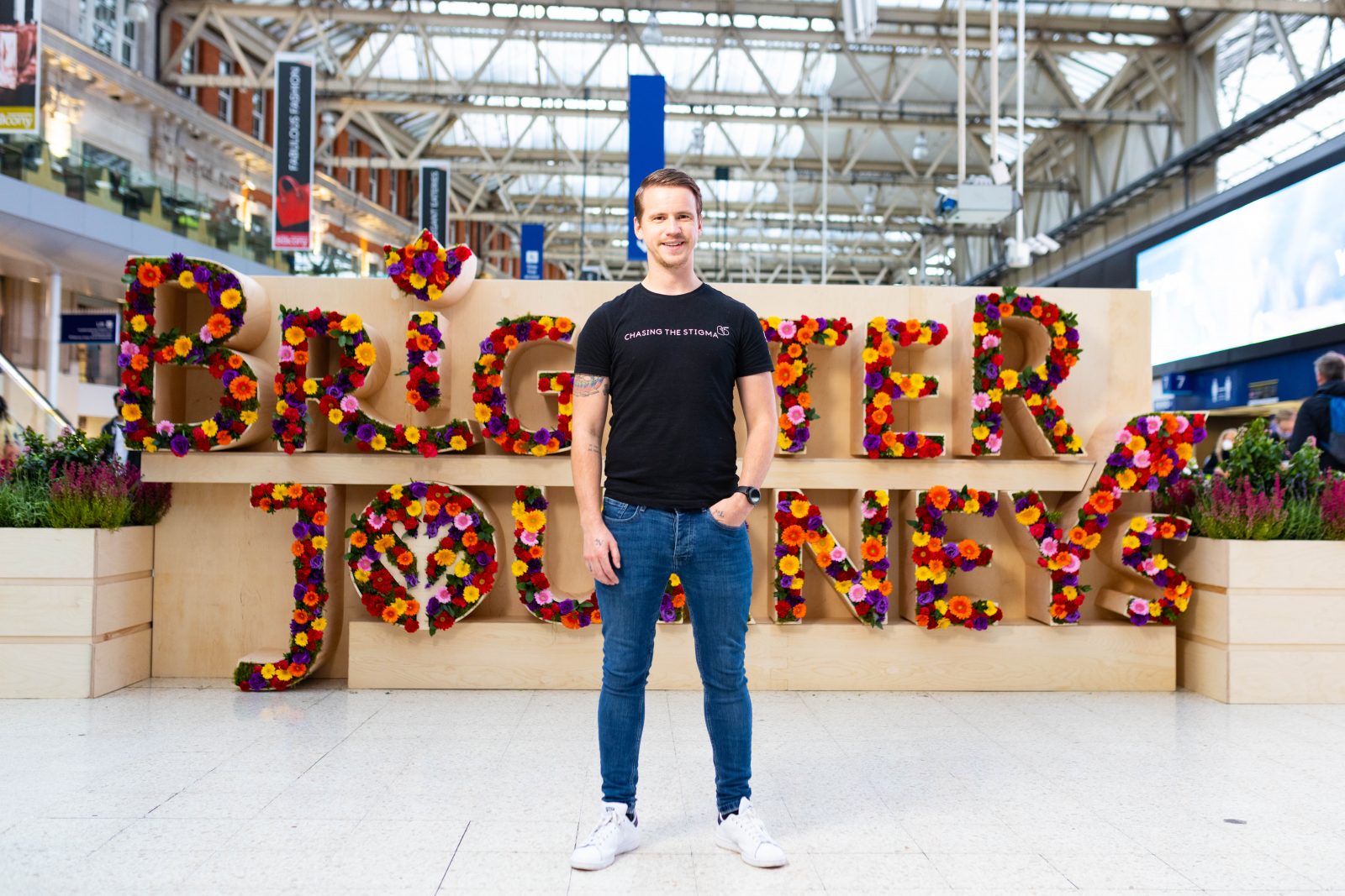 Founder of Chasing the Stigma, Jake Mills, outside the Brighter Days sign.