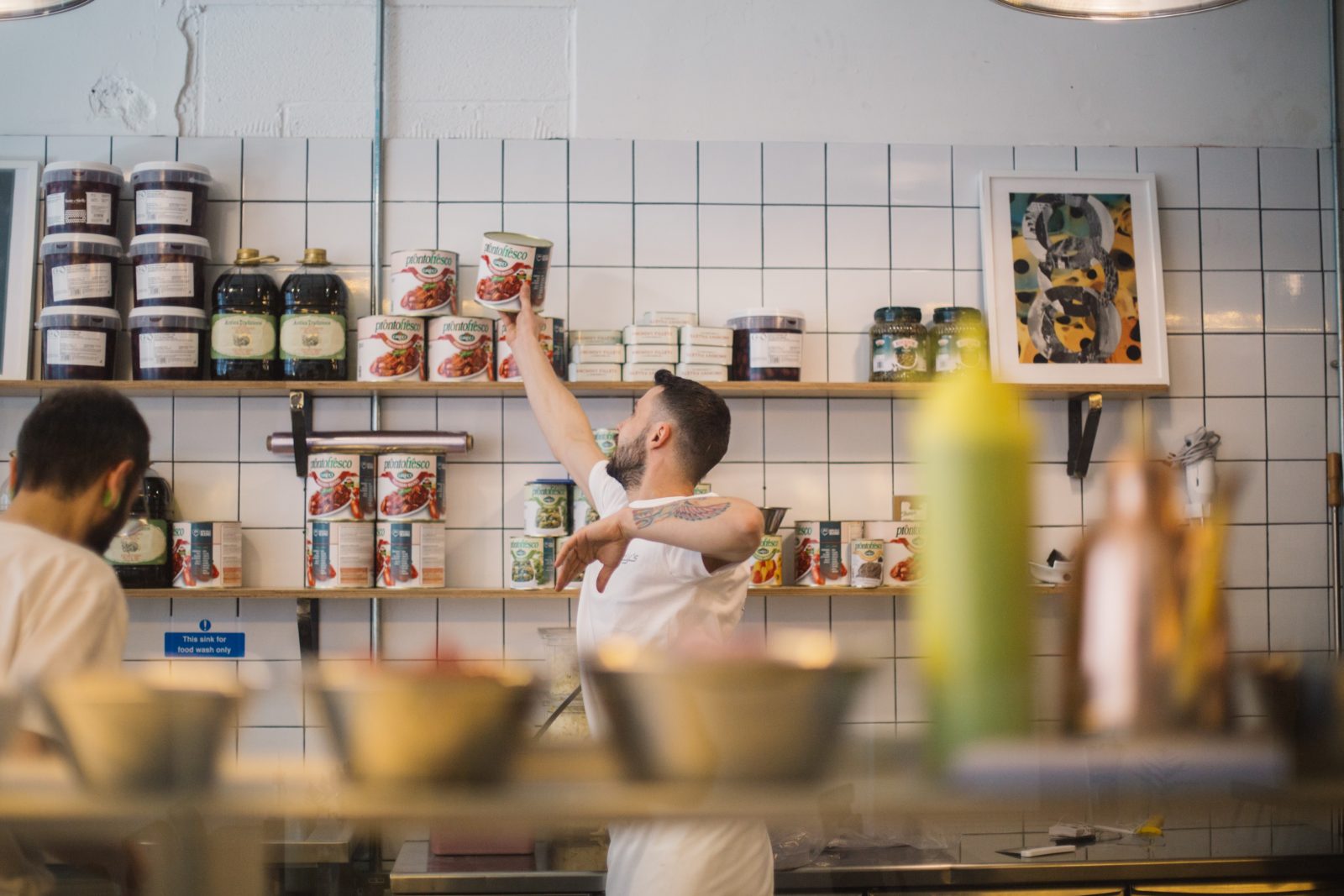 man reaching for tomato.