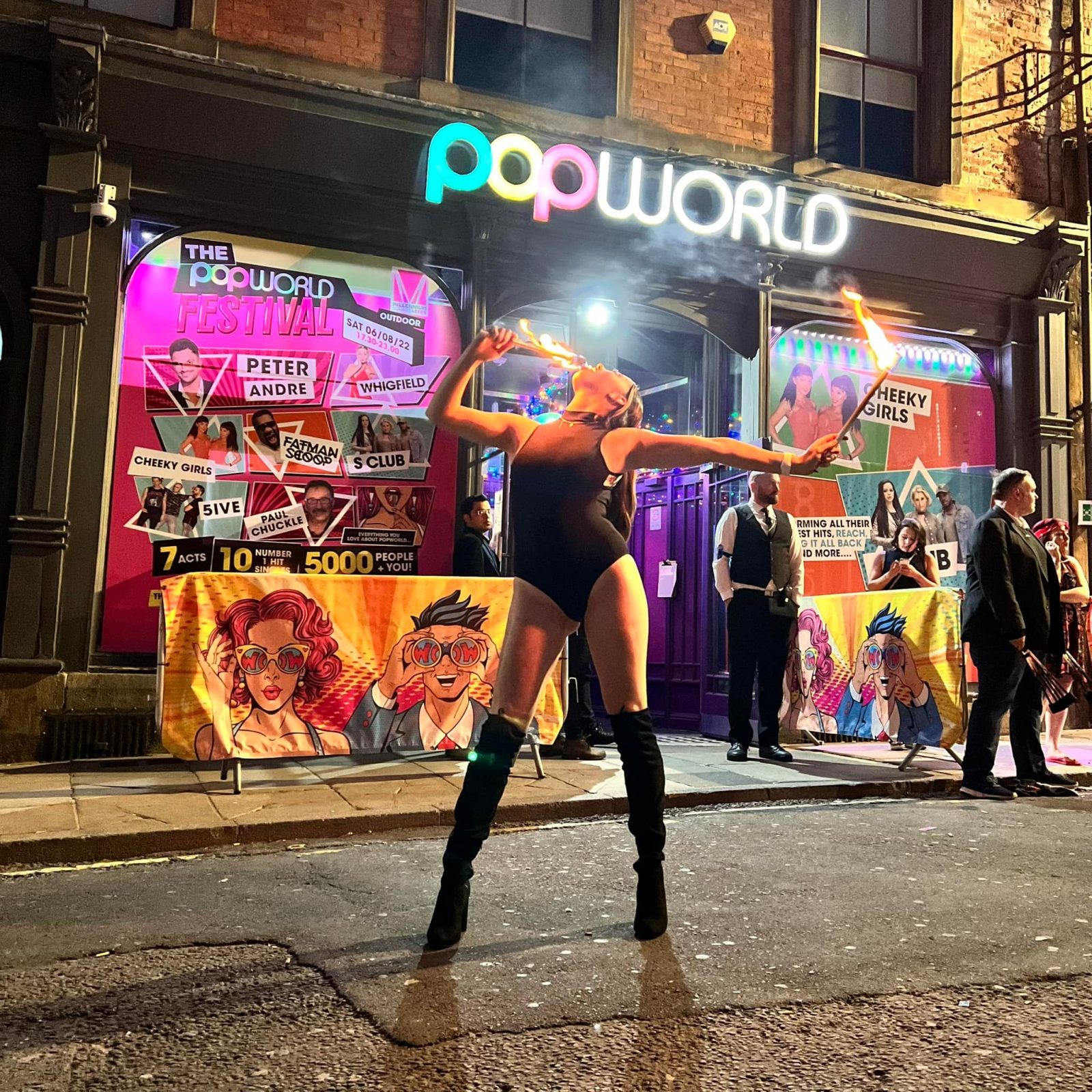 woman with fire outside nightclub.
