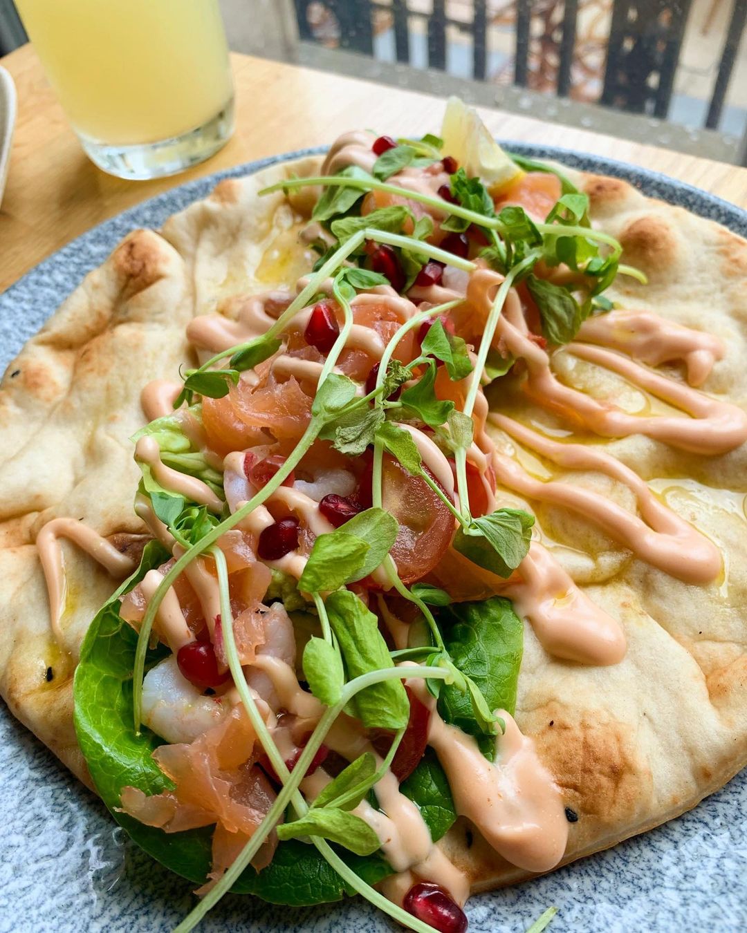 salmon on flatbread with salad.