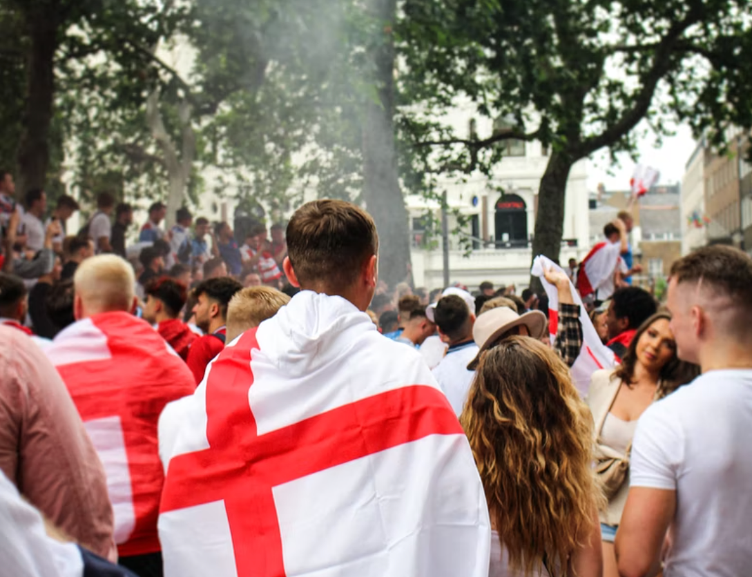 A man with an England flag draped around him. 