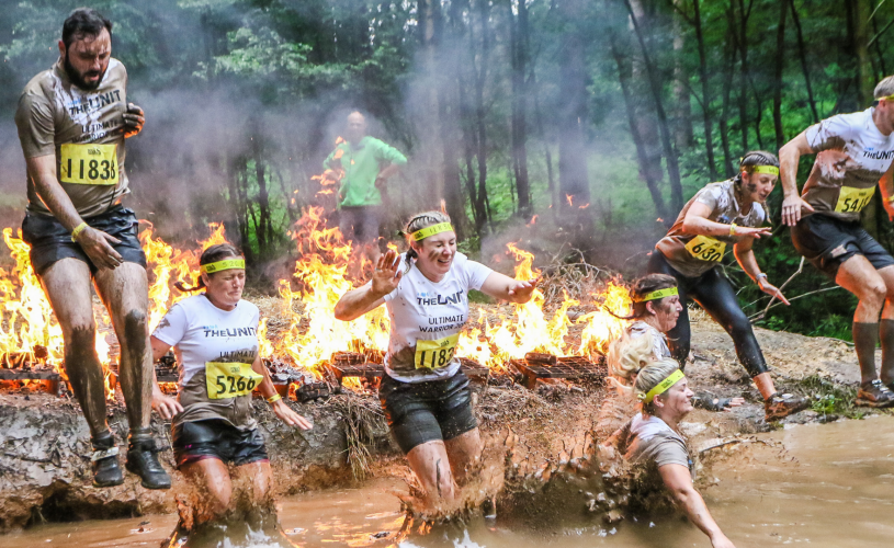 People jumping over the fire pit at Total warrior. 