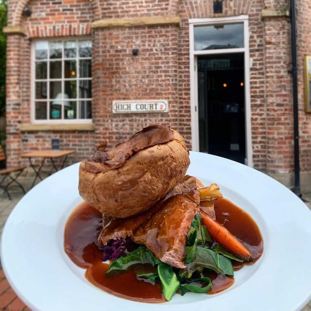 roast dinner held outside brick building.