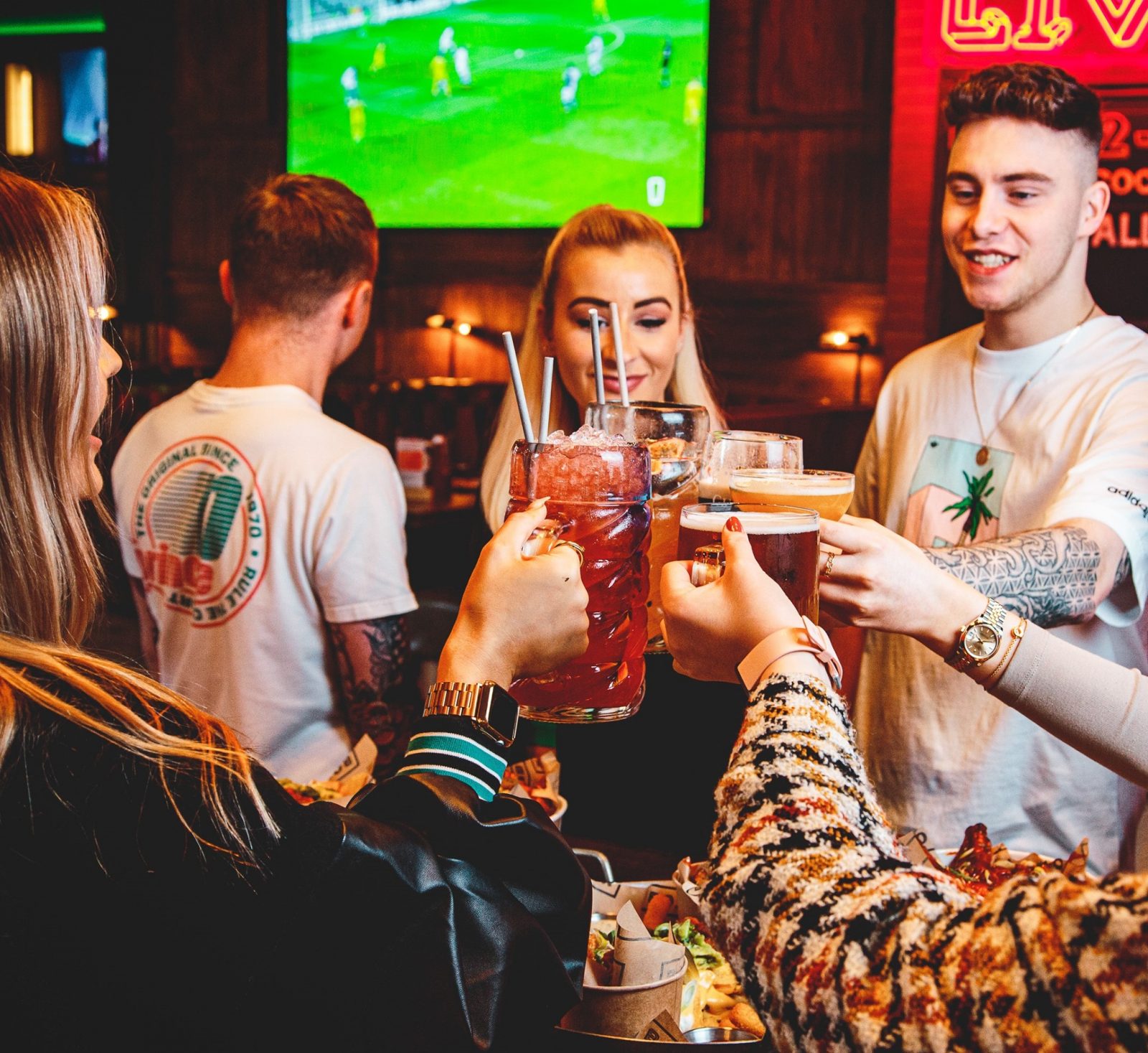 People cheers'ing drinks at Box Bar in Leeds. 