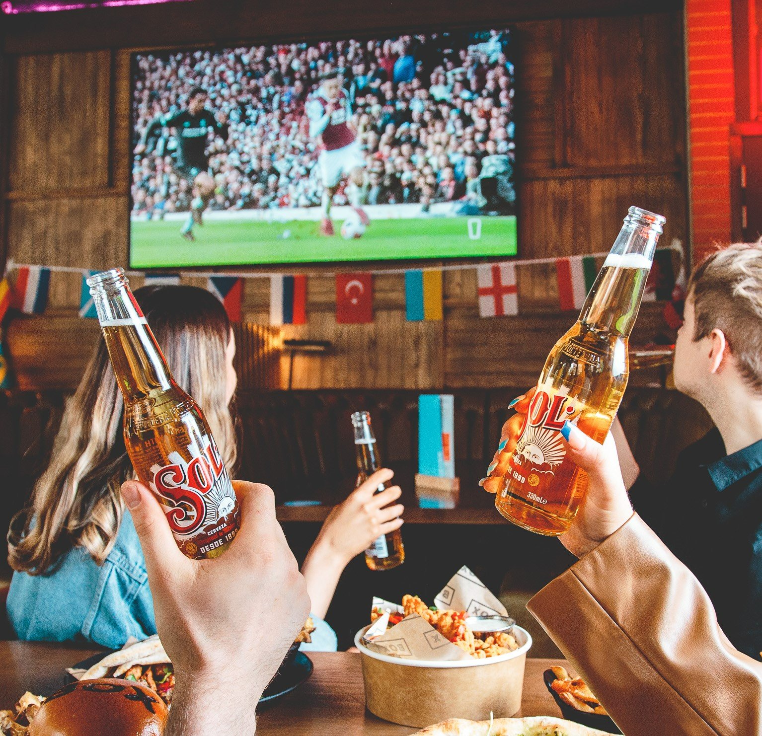 People drinking beer in Box bar. 