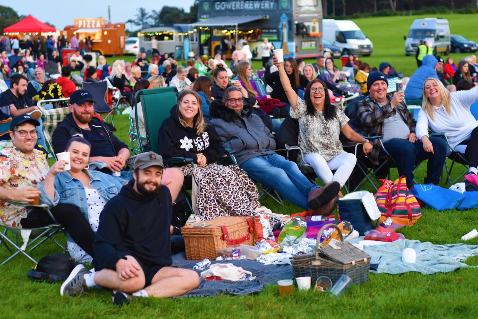 A group of people watching a film at an open-air cinema.