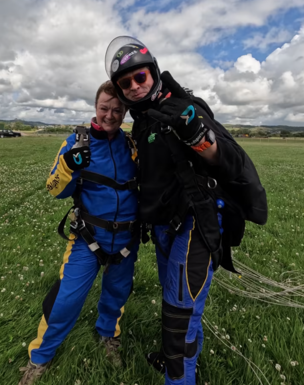 Jane Eccles standing with her instructor after the skydive. 