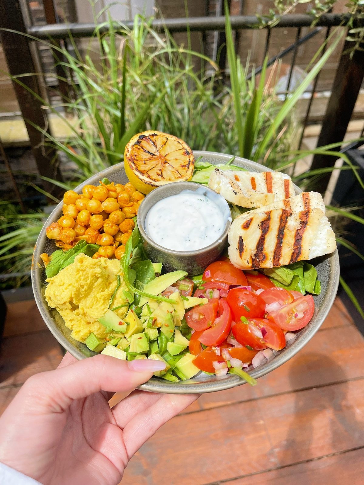 plate with chickpeas, tomatoes and avocado.