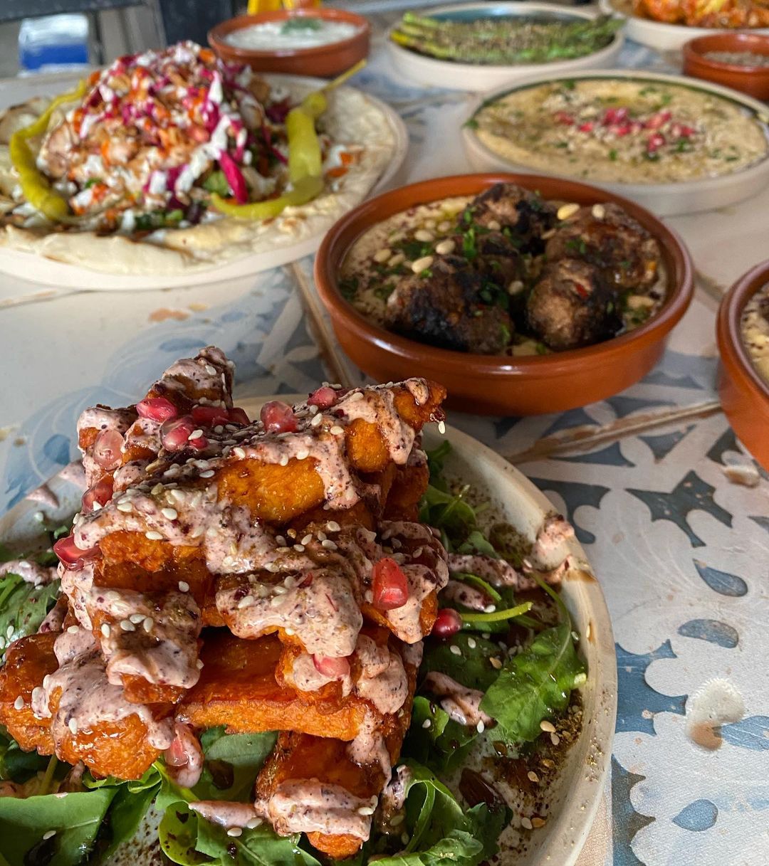 MorMor plates of food, incliding halloumi, pomegrantes and falafels.