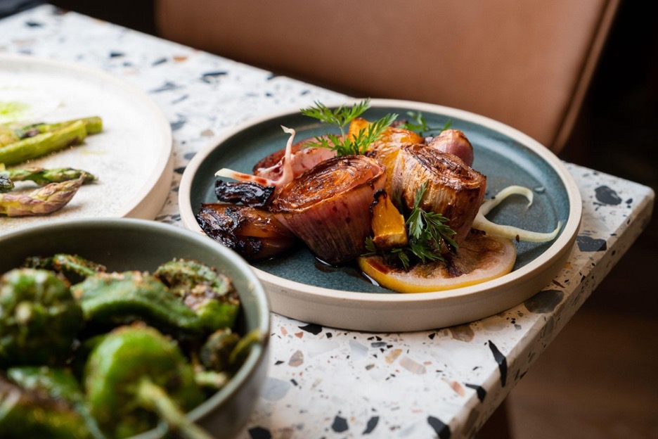 Place of three dishes, padron peppers and charcoal grilled onions. 