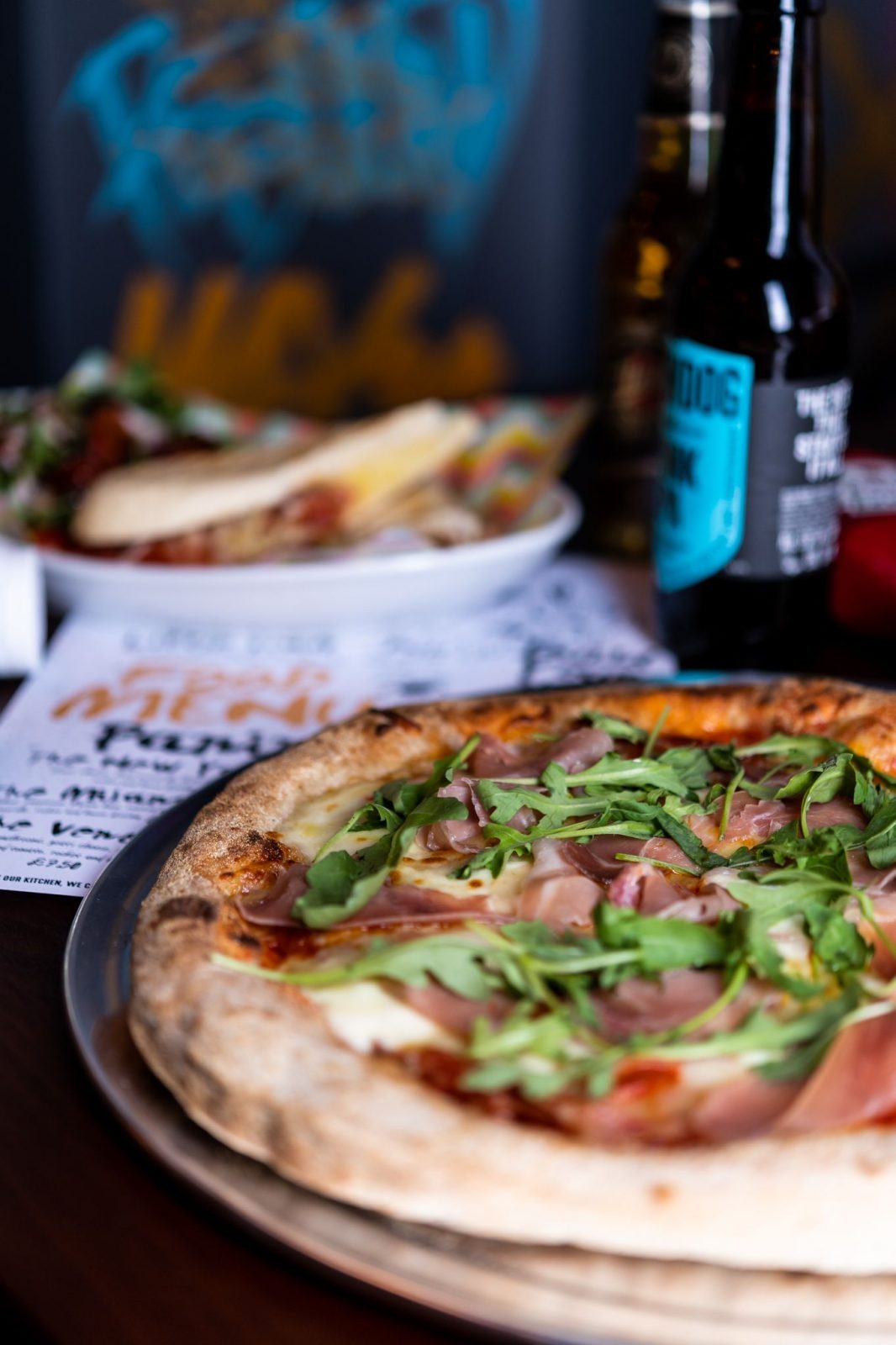 pizza and a Brewdog Punk IPA bottle.