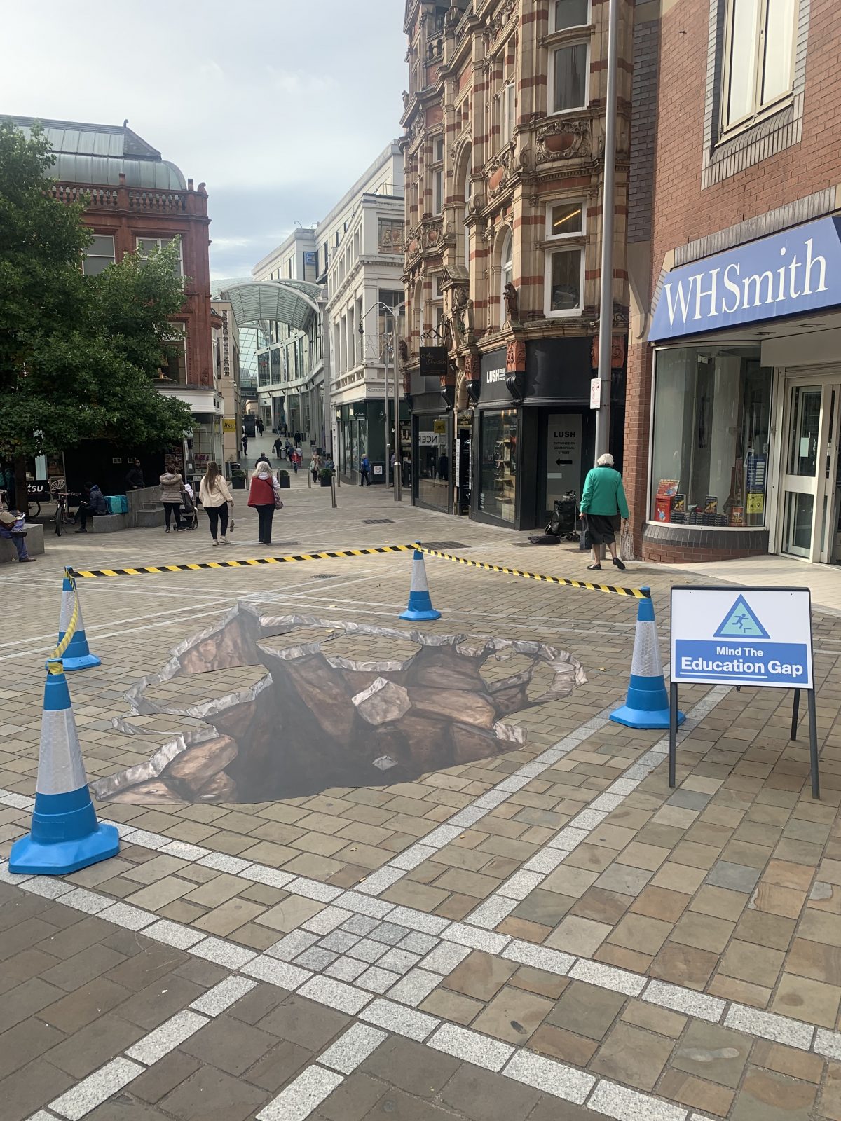 art that makes it look like there's a hole in the ground outside WH Smith.