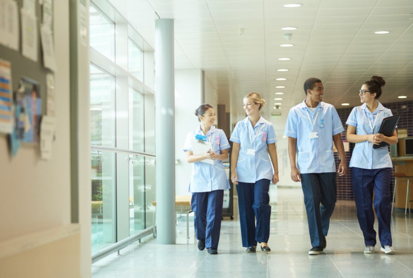 A group of nurses walking through a corridor. 