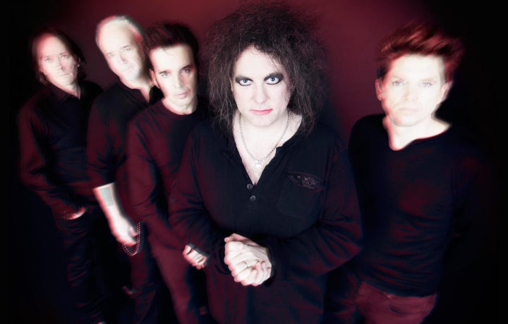 band members of The Cure in a line. 