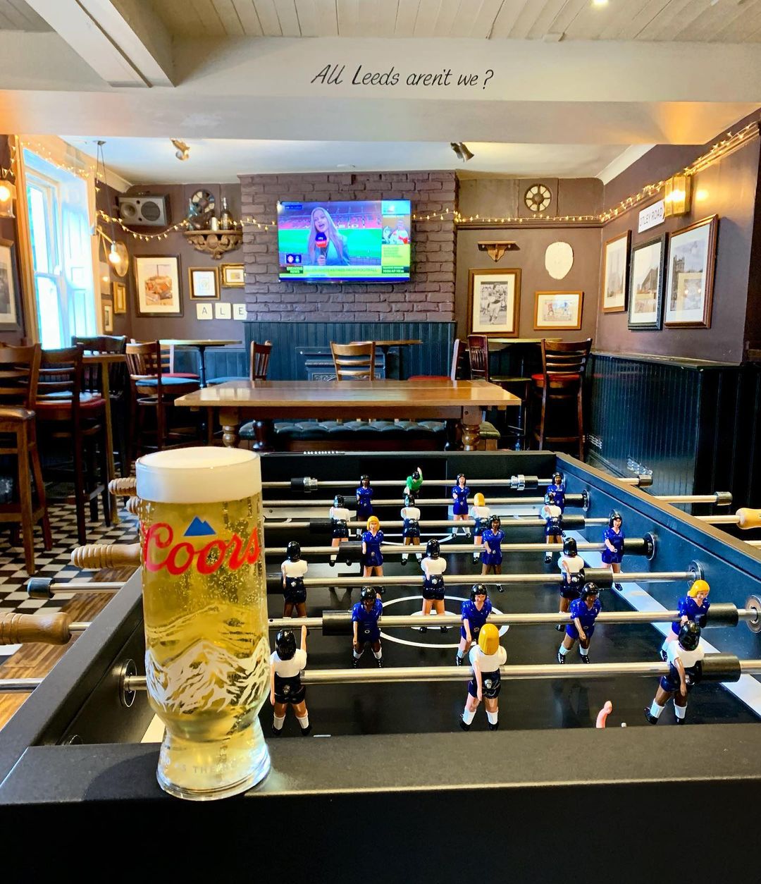 football table with a pint of Coors on it.