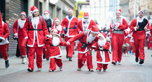 Santas running down the street.