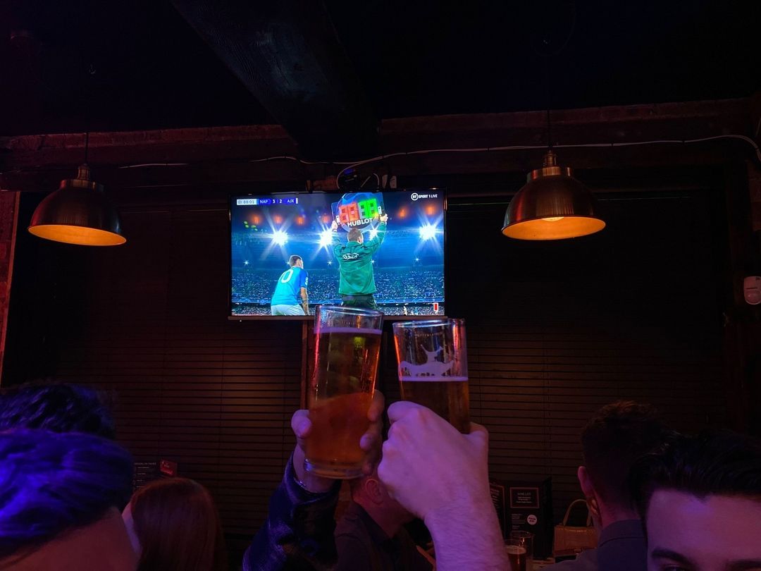 two beers being cheered to the camera.