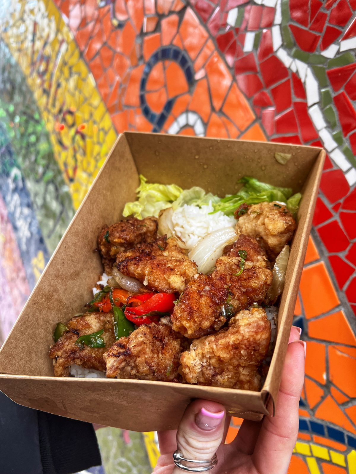 Box of chicken and rice and salad.