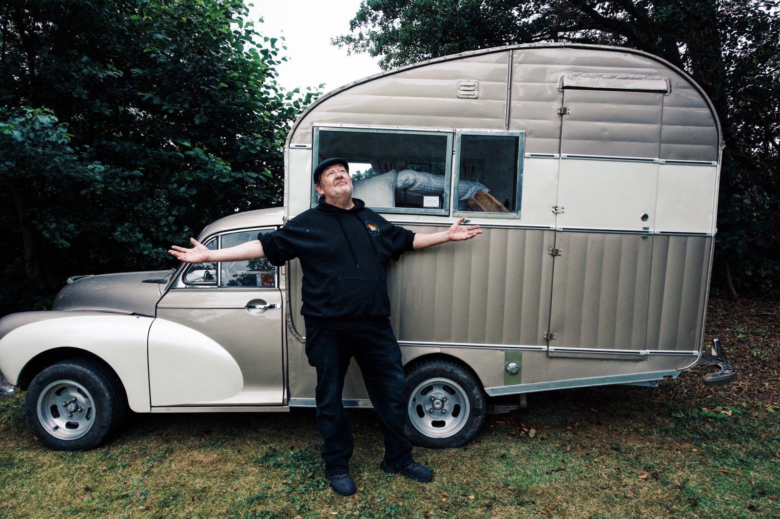 Johnny Vegas posing outside a van.