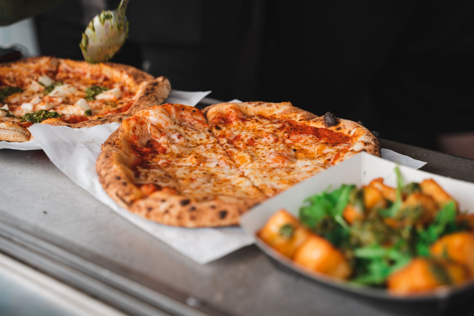 A pizza being sliced. 