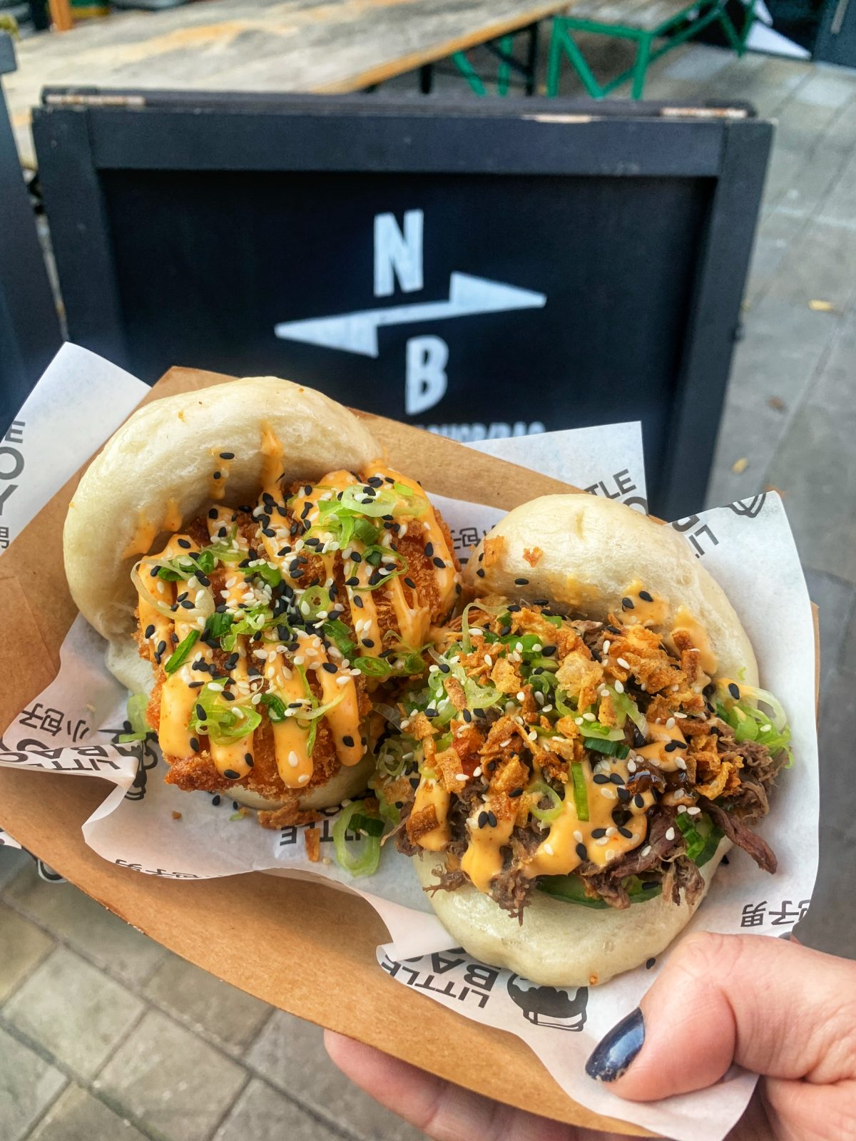 two bao buns held up to camera.