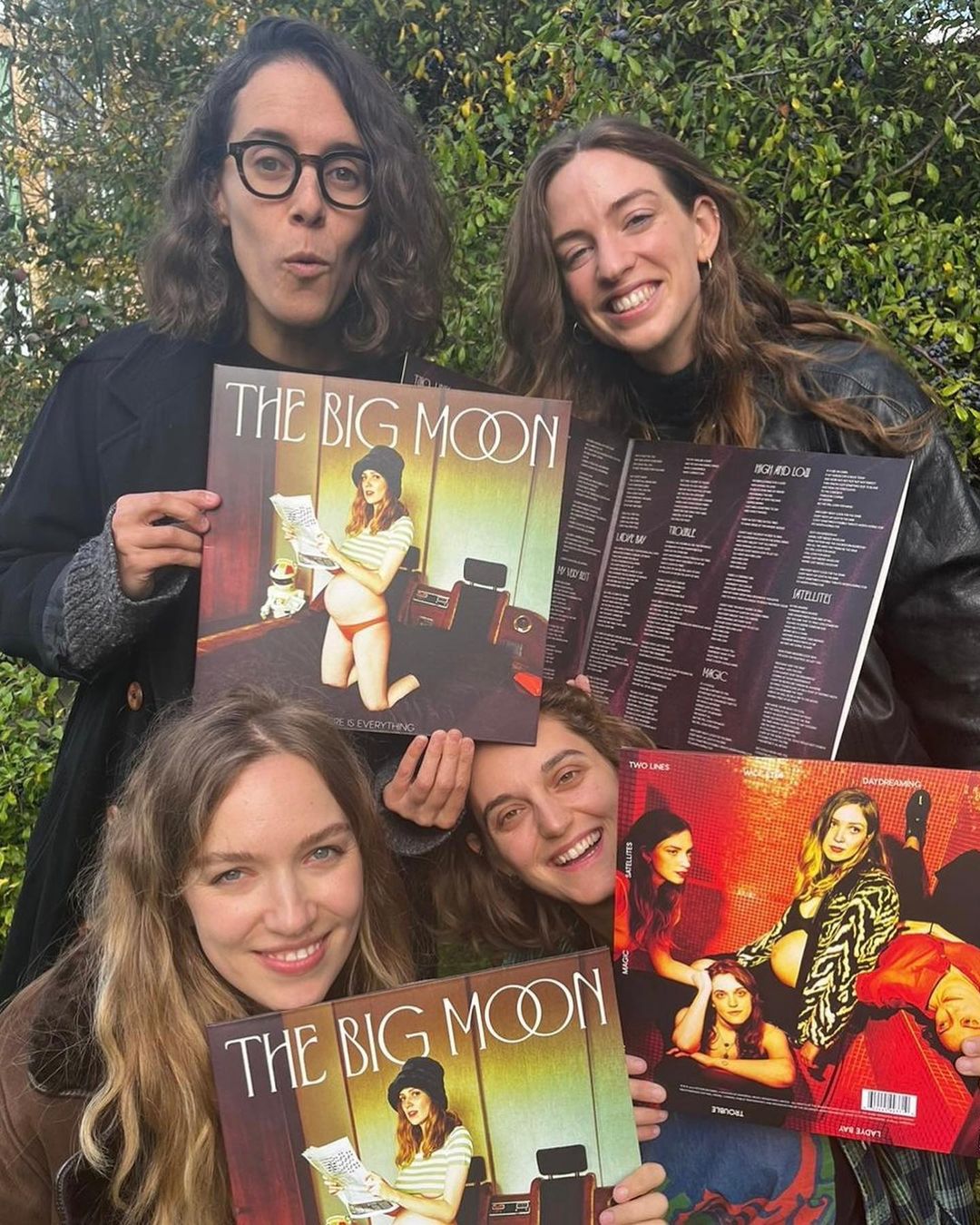 Four people holding records.
