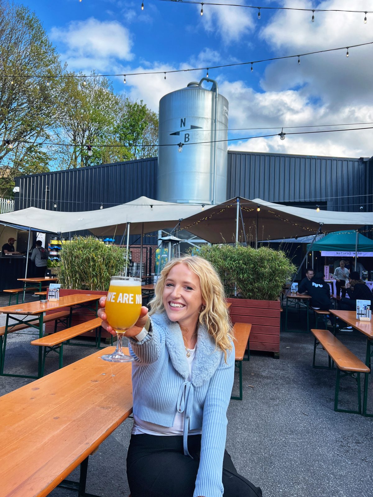 person holding a beer to the camera.