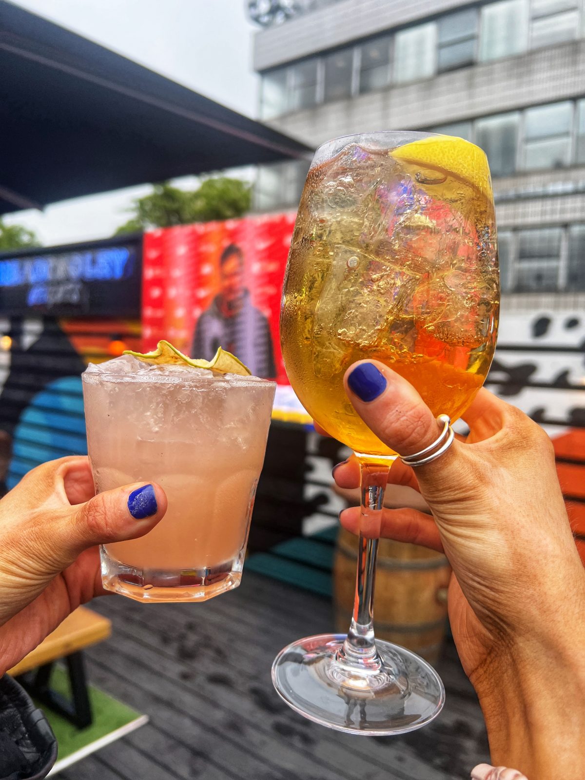 two cocktails held up to camera.