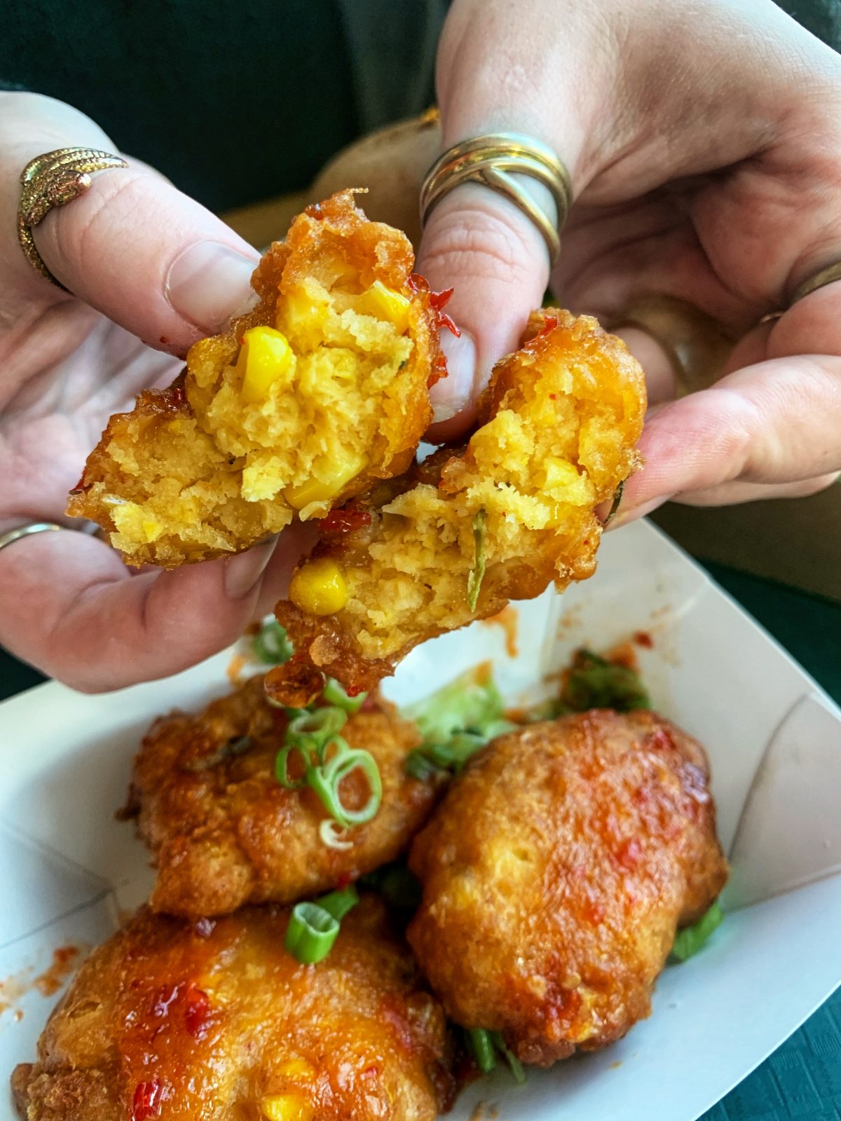 corn cakes held cut in half.