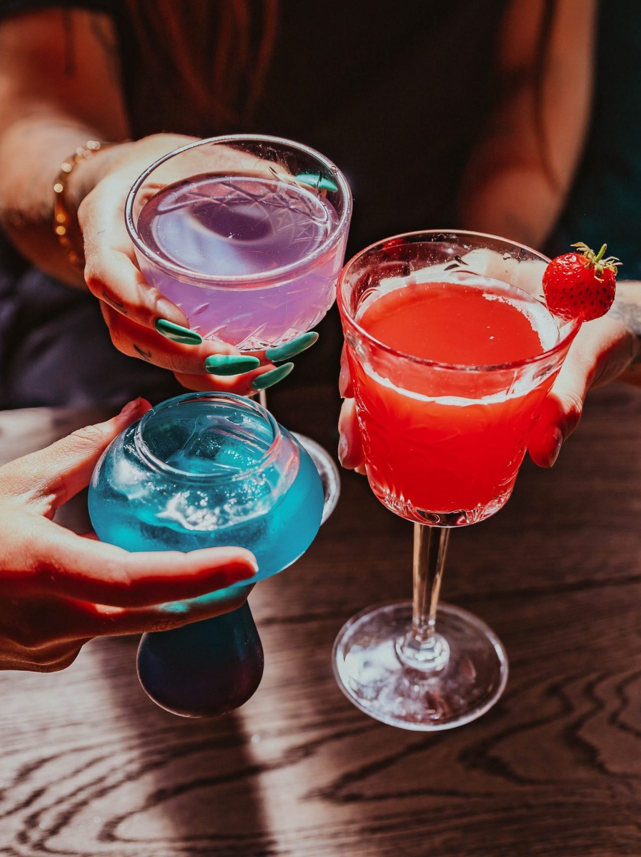 cocktails in different coloured glasses.