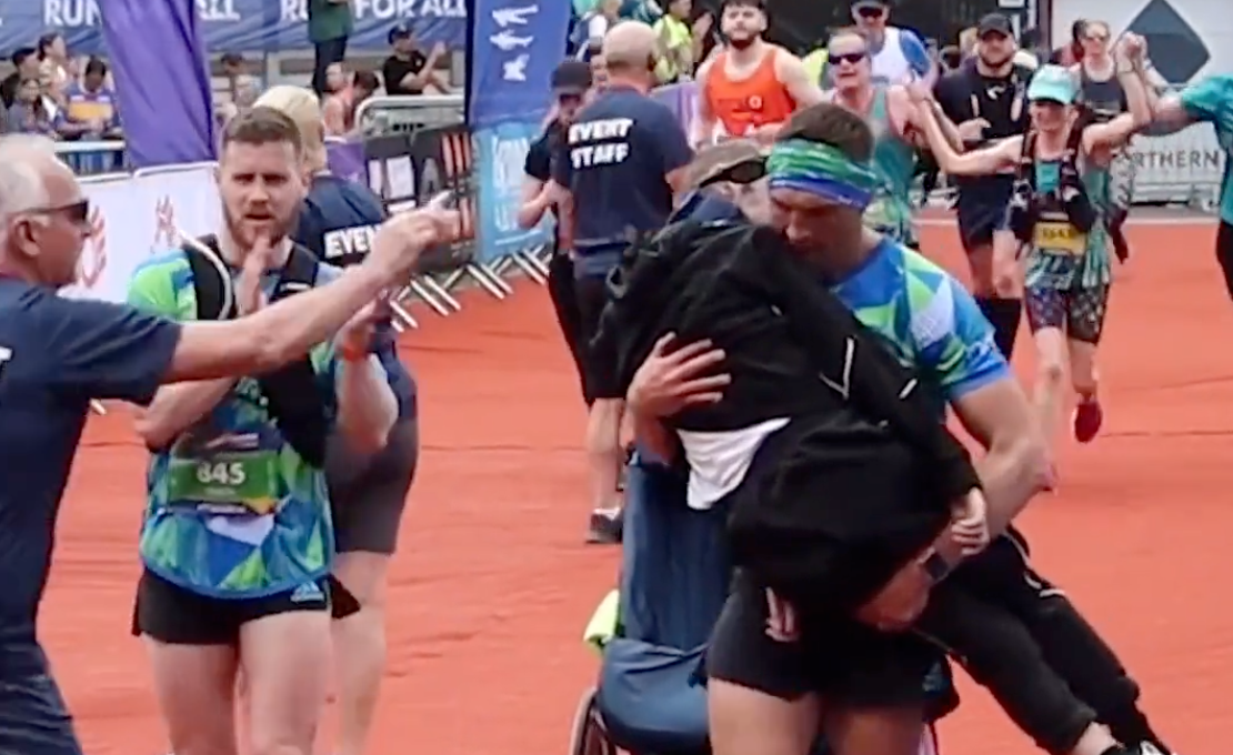 Kevin Sinfield carries Rob Burrow over the finish line at Leeds Marathon