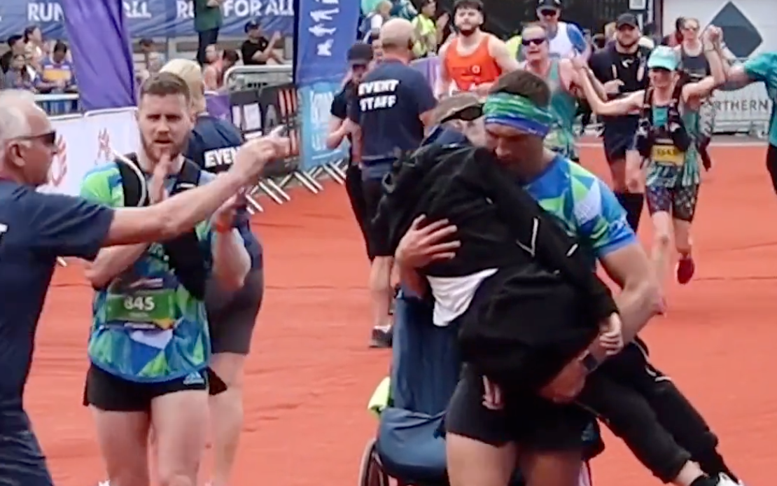 Kevin Sinfield carries Rob Burrow over the finish line at Leeds Marathon